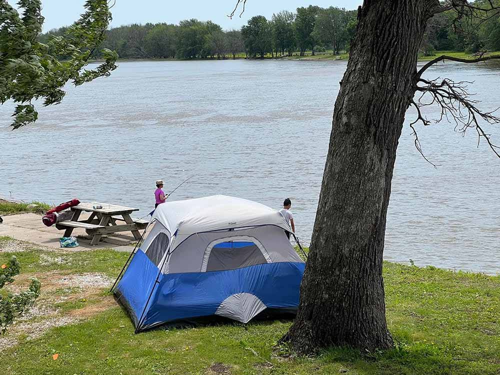 A tent site by the water at LUNDEEN'S LANDING