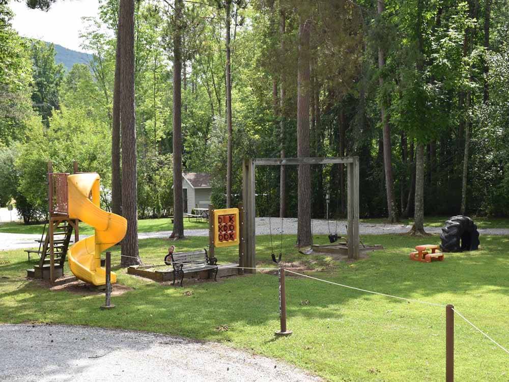 A playground with slide and swing set at DORSET RV PARK