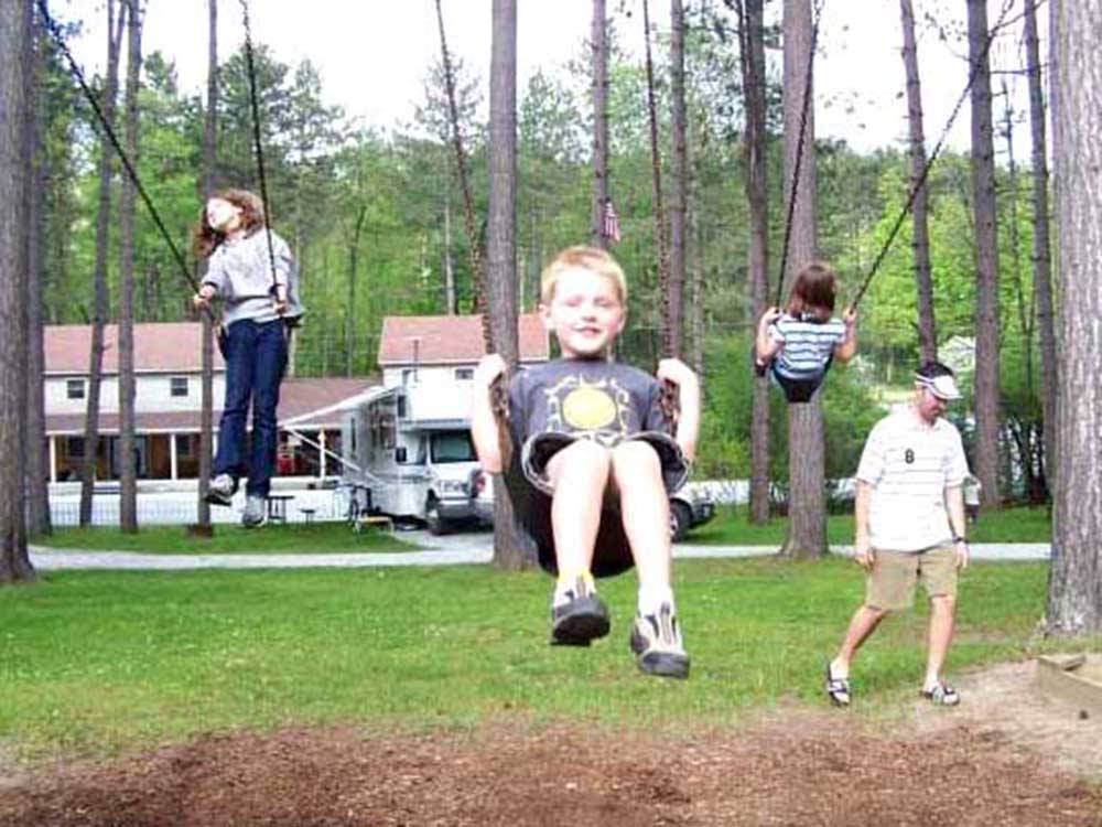 A group of kids on a swing set at DORSET RV PARK
