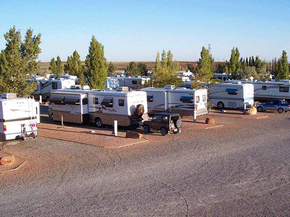 Motorhomes parked in a row in gravel sites at METEOR CRATER RV PARK