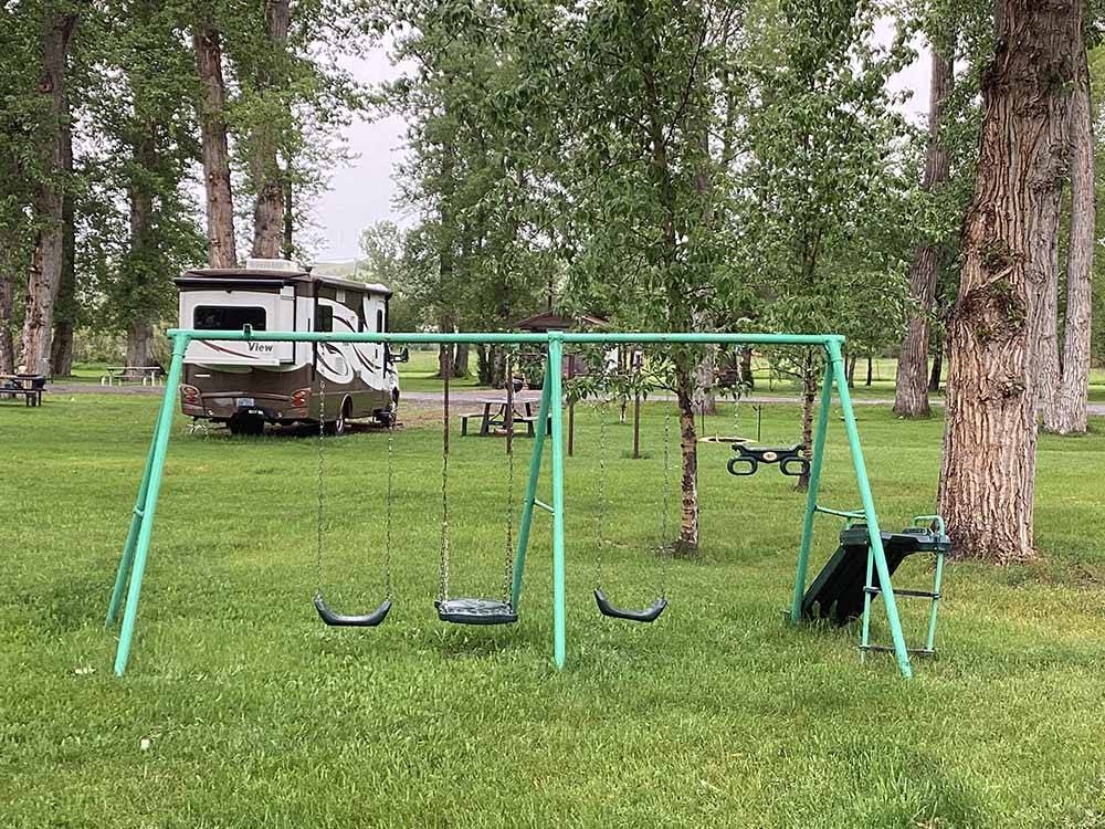 A swing set and slide  at RIVERFRONT RV PARK