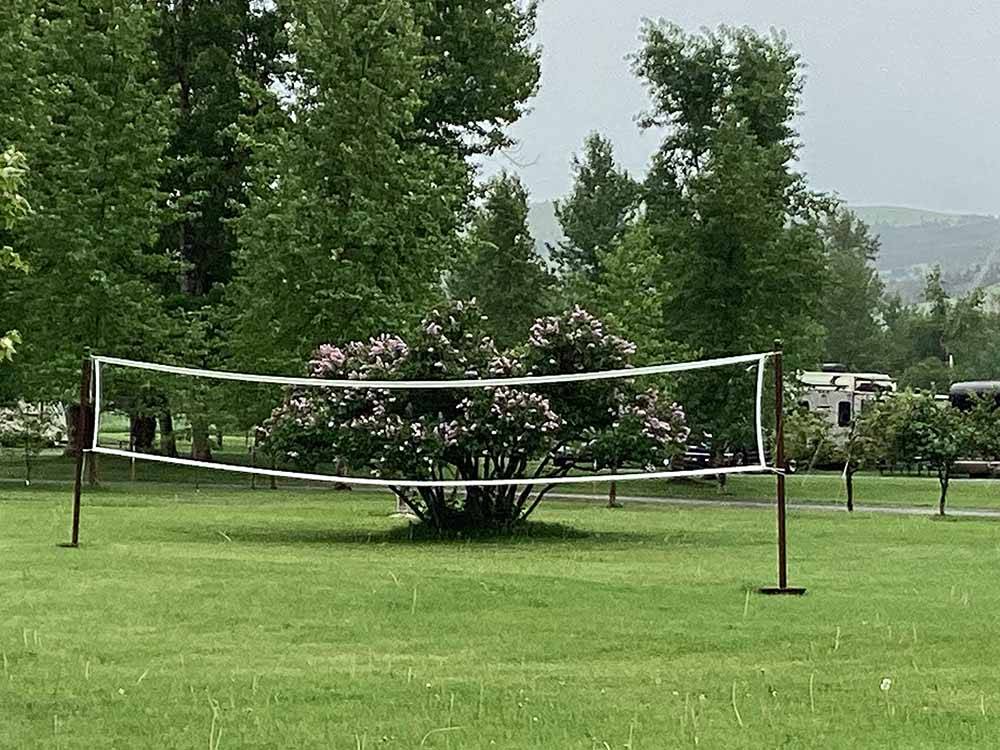 A volleyball net in a grassy area at RIVERFRONT RV PARK