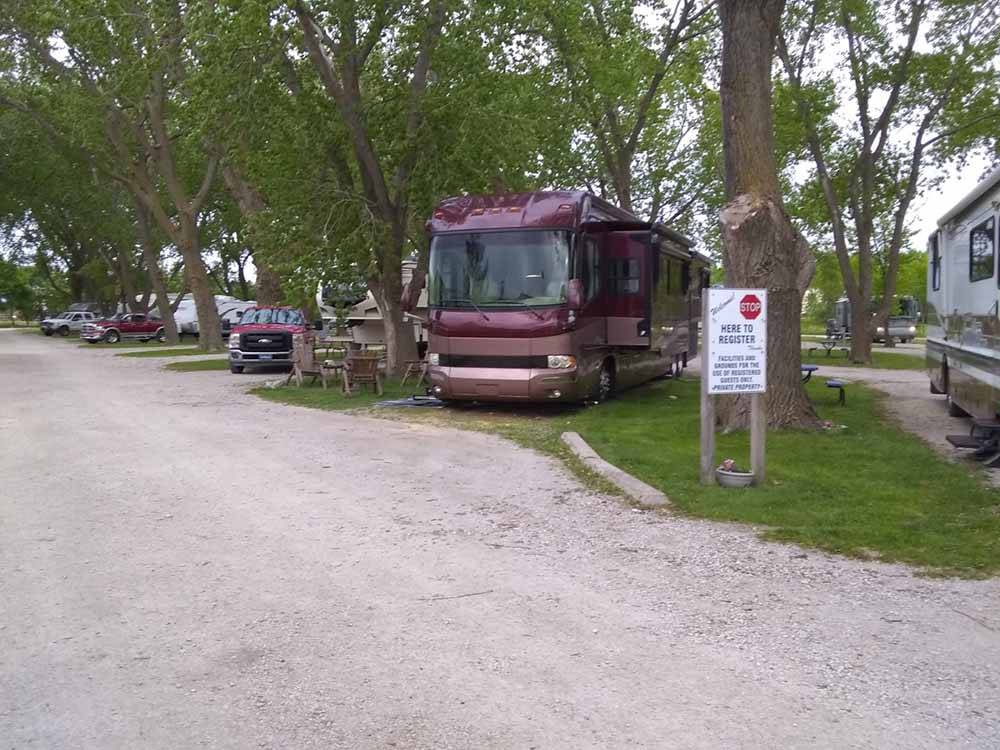 Gravel RV sites with large trees at ON-UR-WA RV PARK