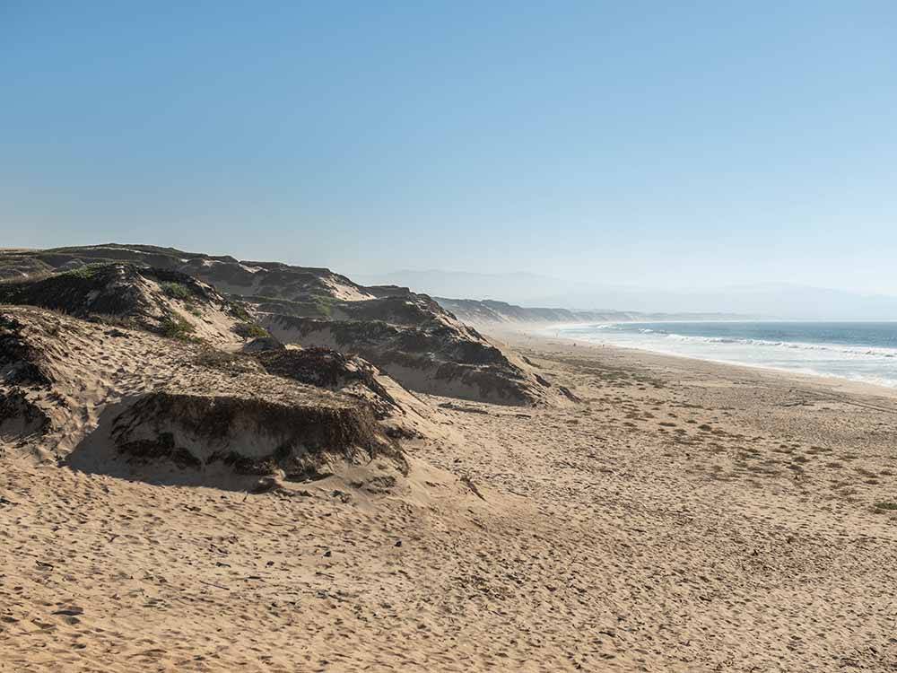 The sandy beach nearby at MARINA DUNES RV RESORT