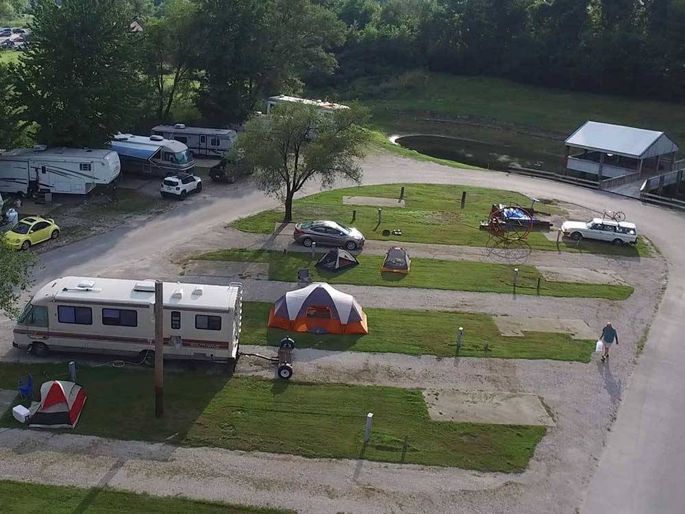 Aerial view of RVs, Trailers, tents and vehicles in grassy and dirt spots at CAHOKIA RV PARQUE
