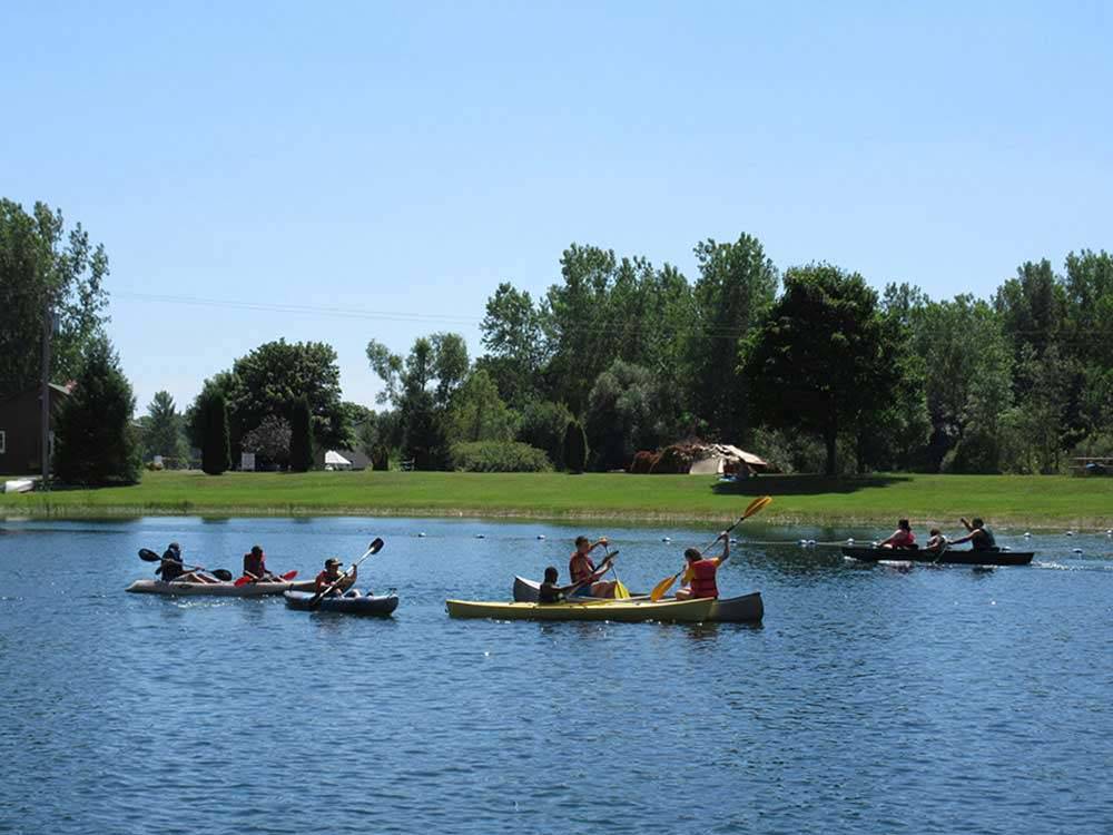 A group of people in canoes on the lake at NIAGARA COUNTY CAMPING RESORT