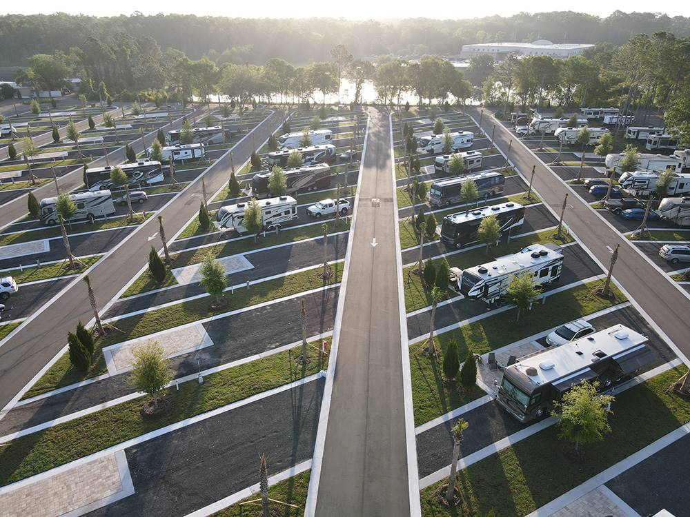 Paved RV sites with water in background at ST AUGUSTINE RV RESORT