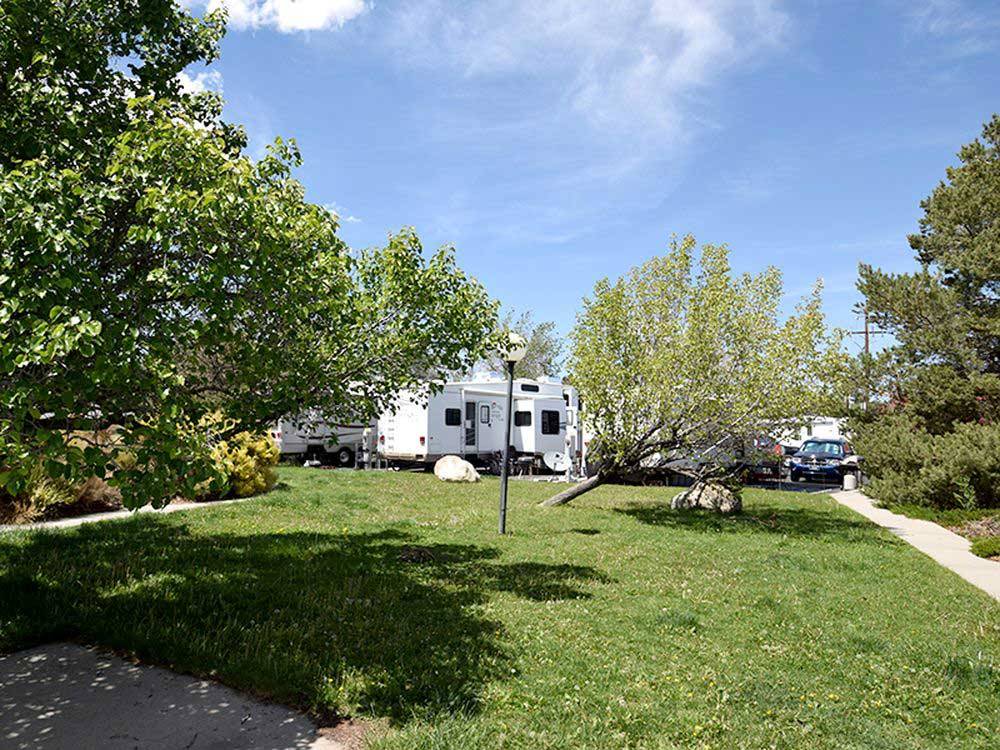 White RVs parked near outdoor light and green grass at KEYSTONE RV PARK
