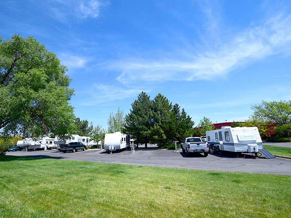 Trucks and RVs parked on concrete spaces at KEYSTONE RV PARK