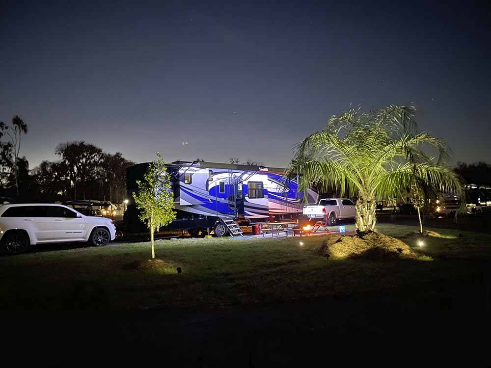 A trailer in an RV site at night at OCALA NORTH RV RESORT