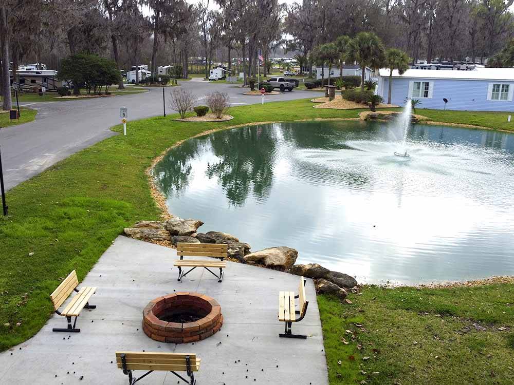 A fire pit next to the pond at OCALA NORTH RV RESORT