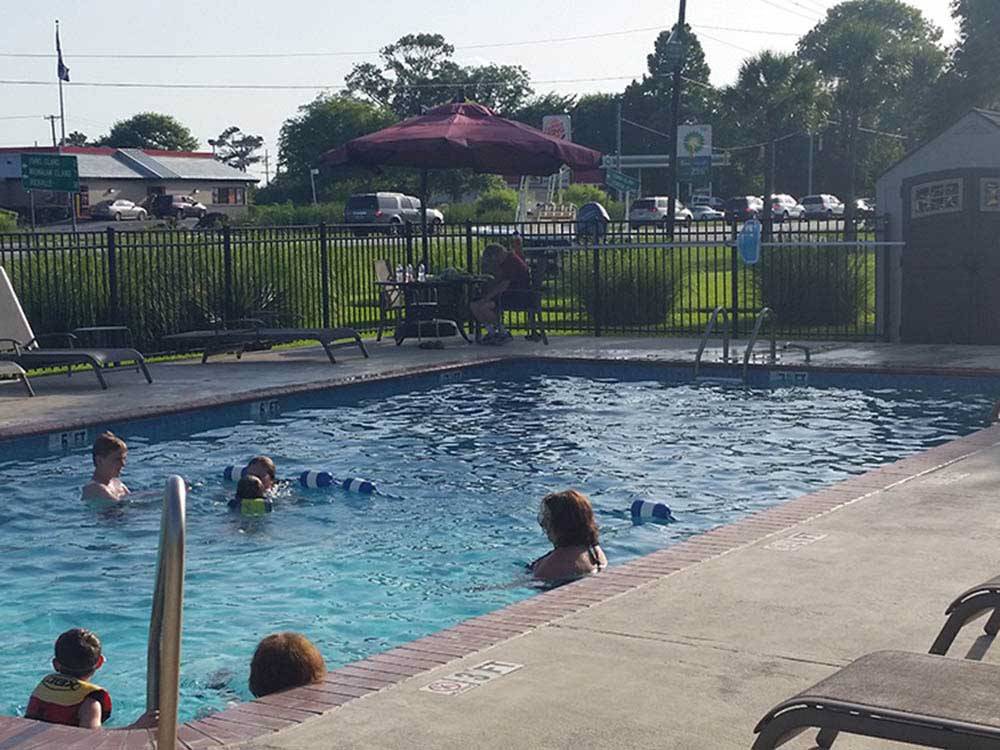 People swimming in the pool at OAK PLANTATION CAMPGROUND