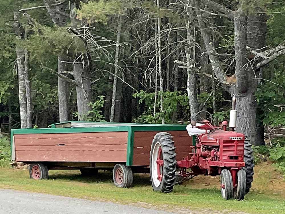 A red tractor and wagon at PAUL BUNYAN CAMPGROUND