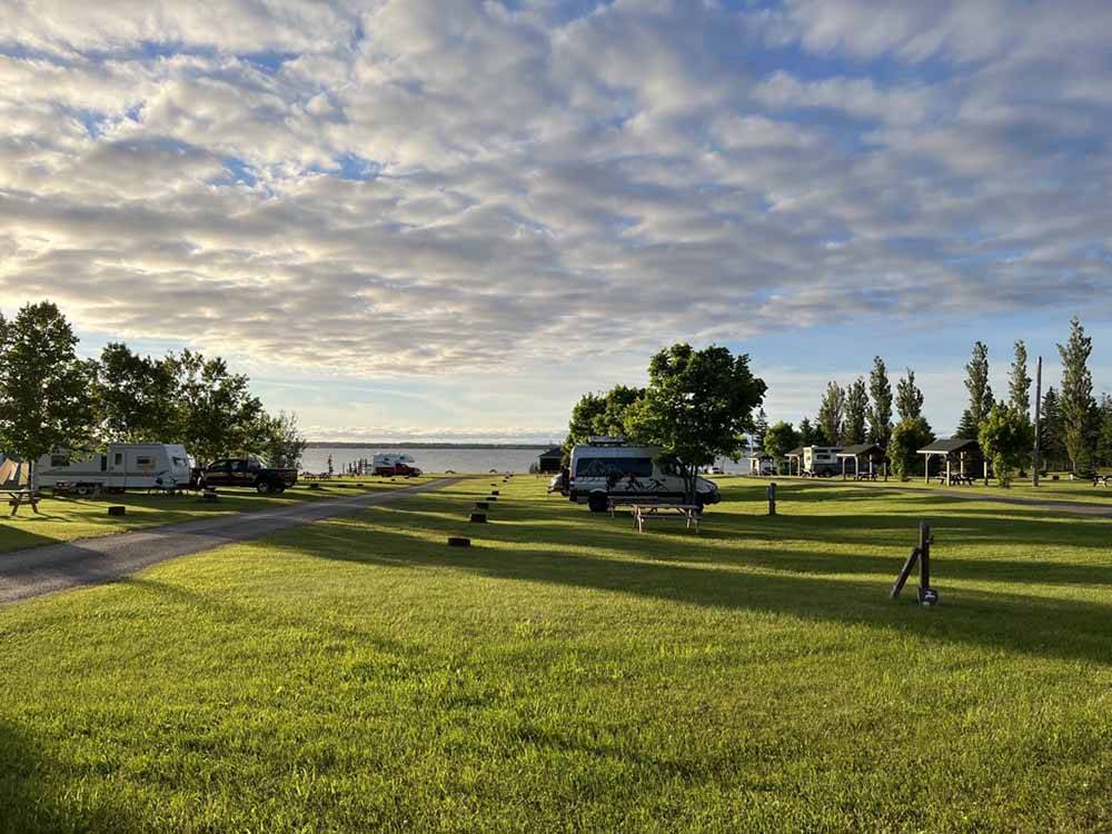 A group of grassy RV sites at CAMPING COLIBRI BY THE SEA