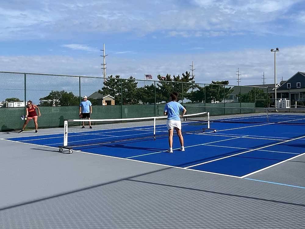 People playing pickleball at CAMP HATTERAS RV RESORT & CAMPGROUND