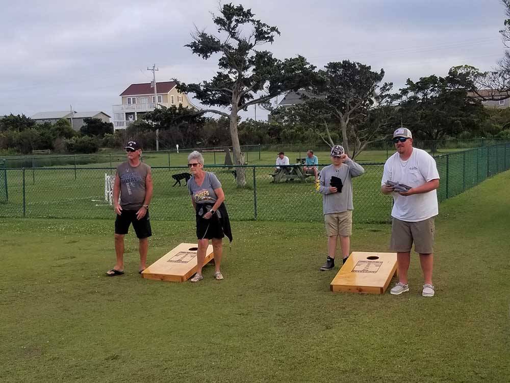 People playing cornhole at CAMP HATTERAS RV RESORT & CAMPGROUND