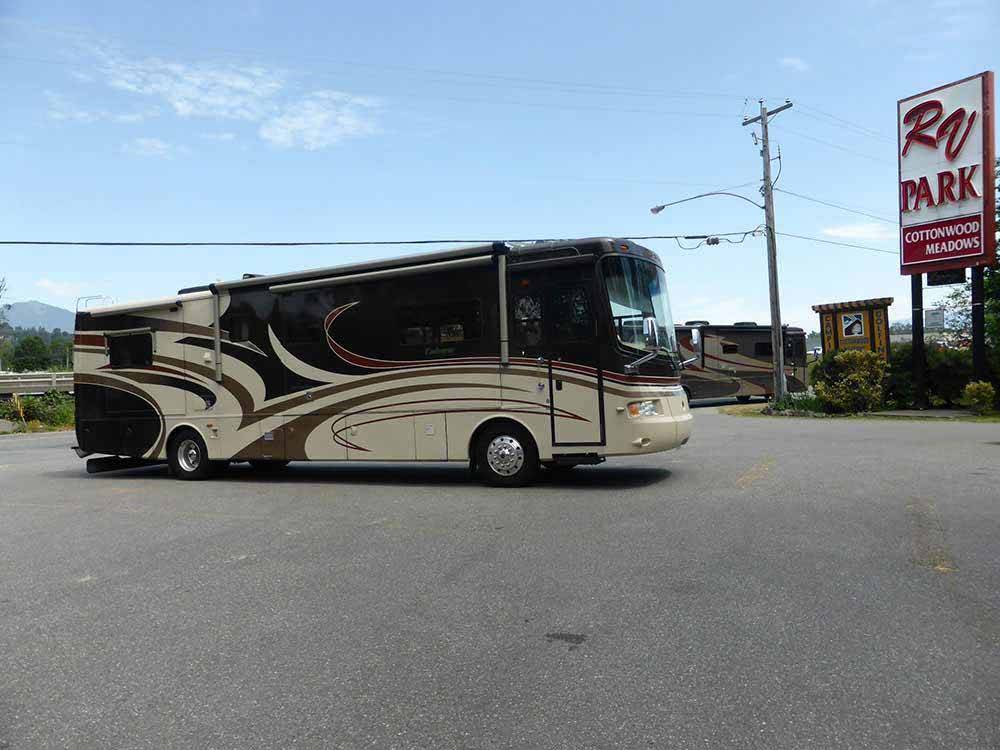 A class A motorhome in front of the resort at COTTONWOOD MEADOWS RV COUNTRY CLUB