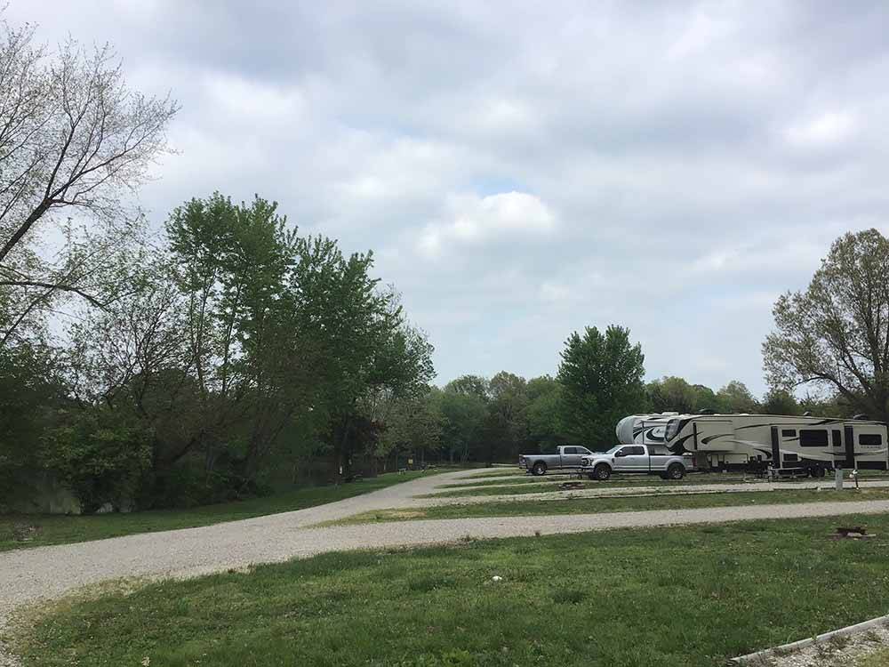 A row of gravel RV sites at RUSTIC TRAILS RV PARK