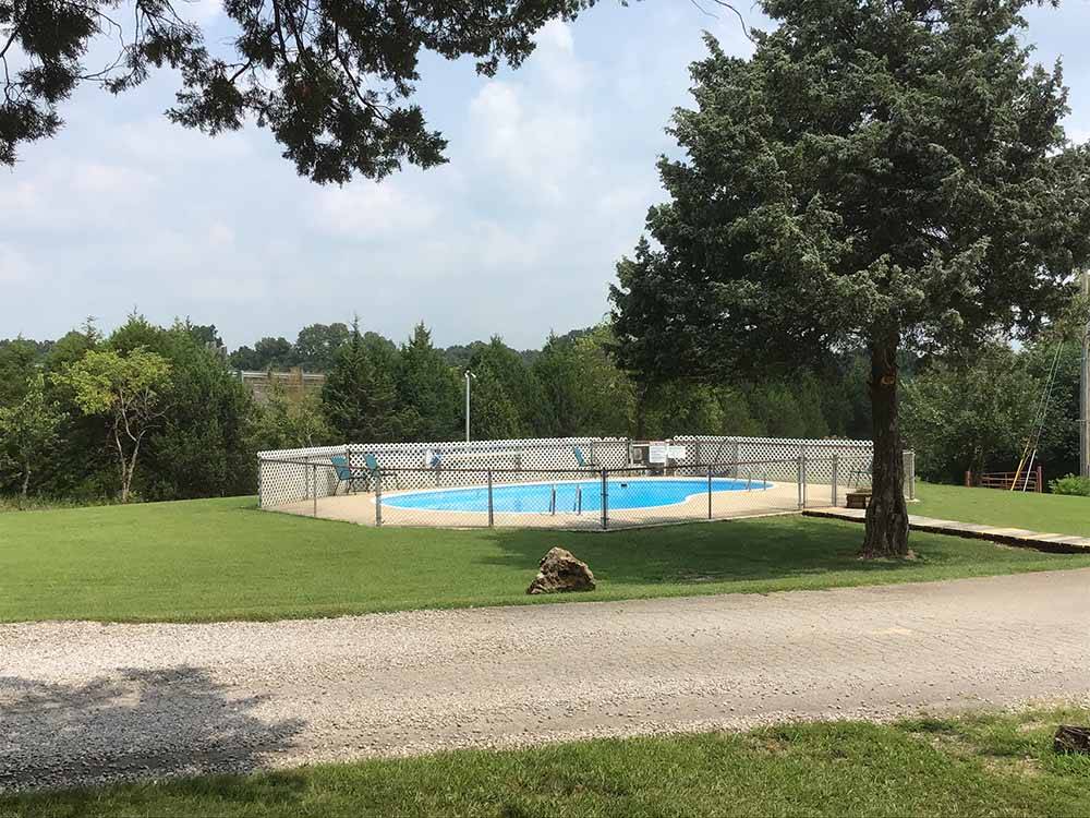 The fenced in swimming pool at RUSTIC TRAILS RV PARK