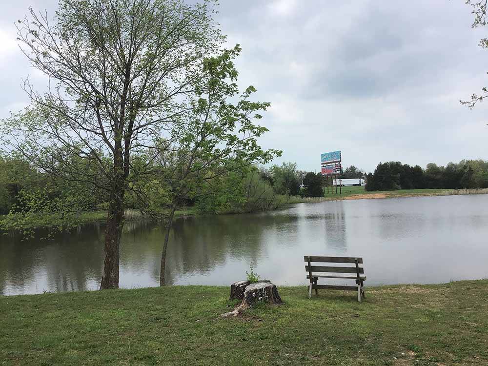 A park bench overlooking the water at RUSTIC TRAILS RV PARK