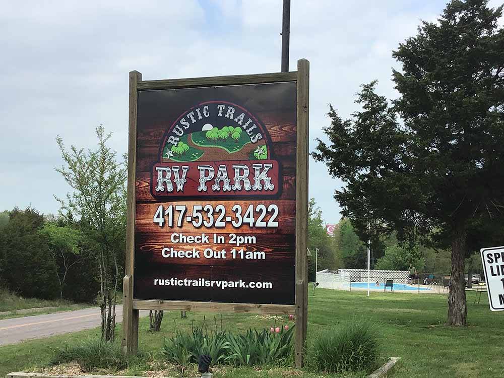 The front entrance sign at RUSTIC TRAILS RV PARK
