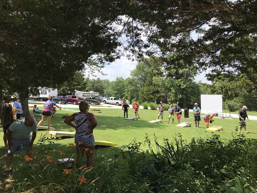People competing at corn hole at LAZY DAY CAMPGROUND
