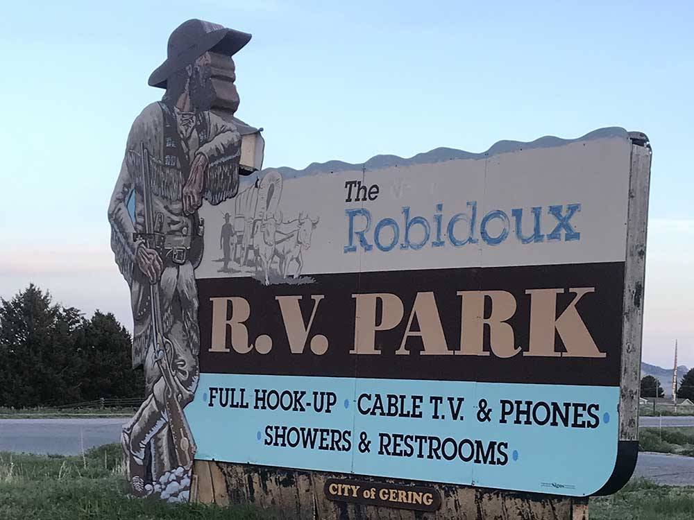 Statue over sign indicating Robidoux RV Park at ROBIDOUX RV PARK