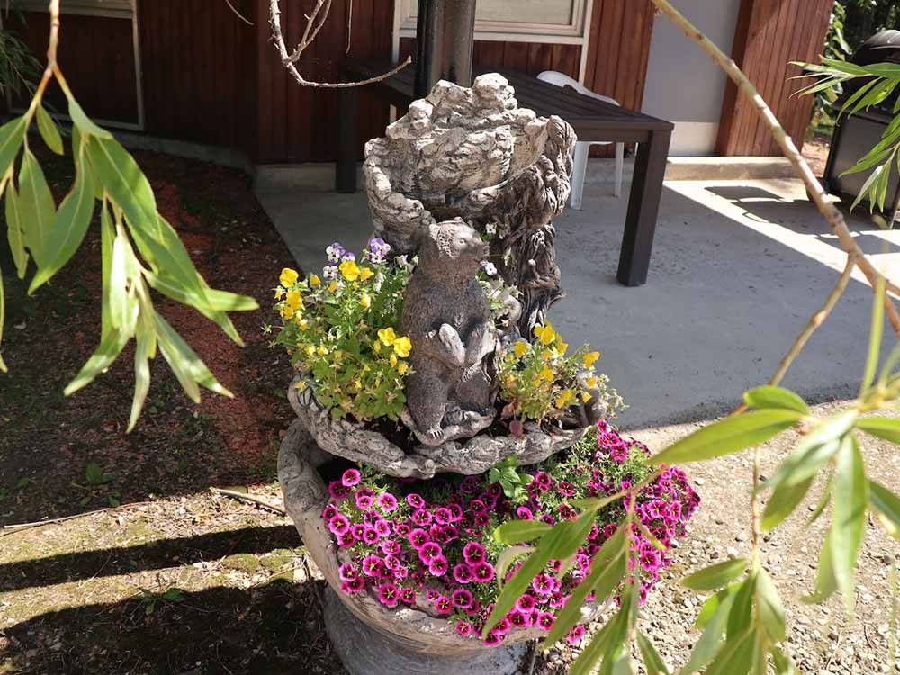 A flower pot with yellow and pink flowers  at SHERK'S RV PARK