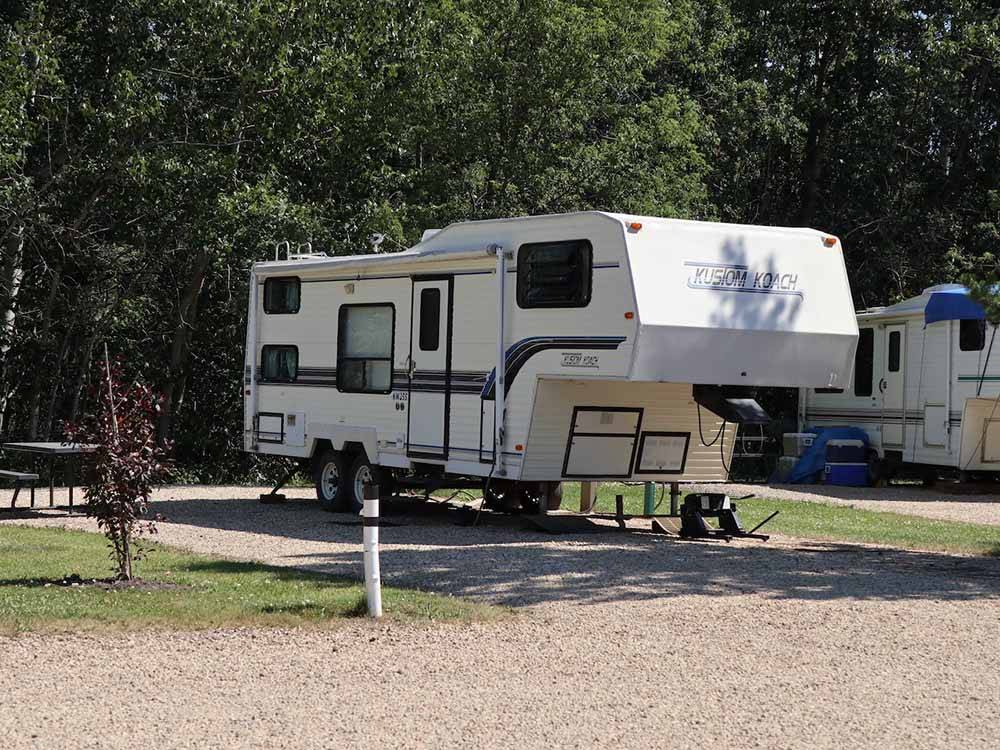 A fifth wheel trailer in a back in RV space at SHERK'S RV PARK