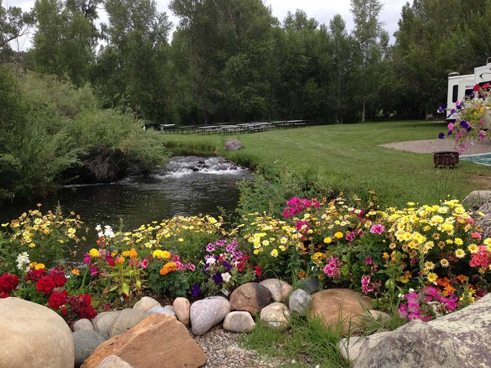 Flower bed with stream and picnic area at OUTDOORSY BAYFIELD