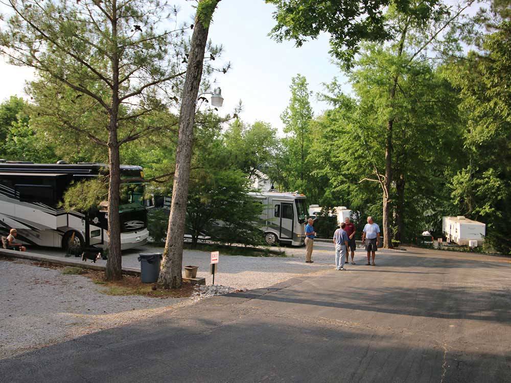 Campers conversing in group beside RV at CAMPGROUND AT BARNES CROSSING