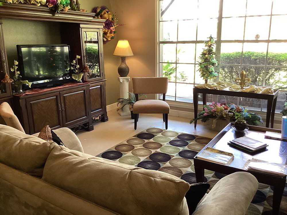 A TV and couch inside at PINE CREST RV PARK OF NEW ORLEANS