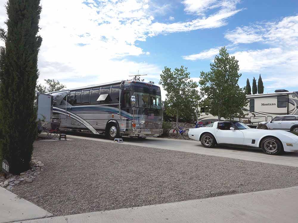 Motorhome and Corvette parked in a RV site at ELEPHANT BUTTE LAKE RV RESORT