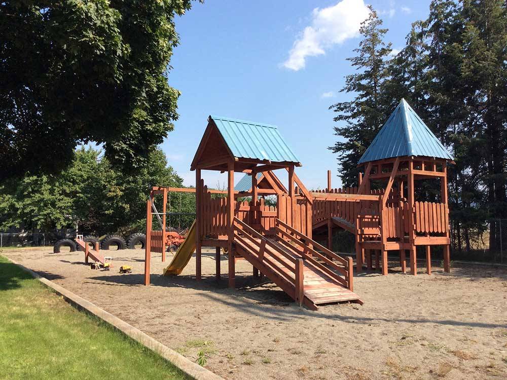 Sand playground with wooden swing set at COEUR D'ALENE RV RESORT