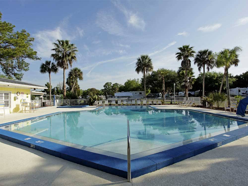 Swimming pool with outdoor seating at ENCORE CRYSTAL ISLES