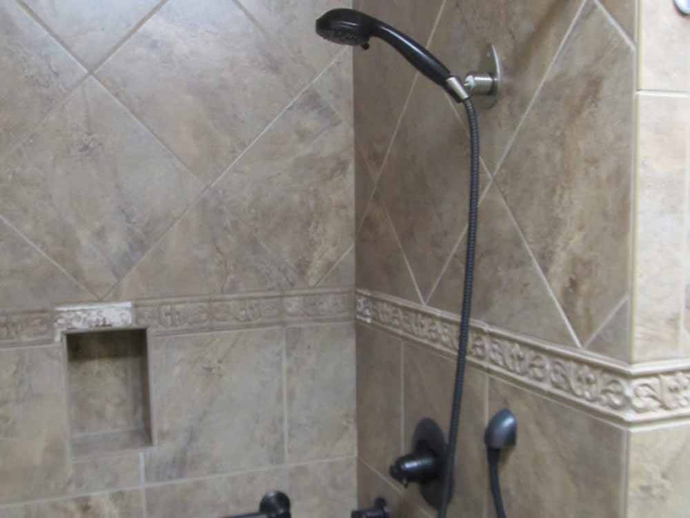 A clean shower stall at PACIFIC PINES RV PARK & STORAGE
