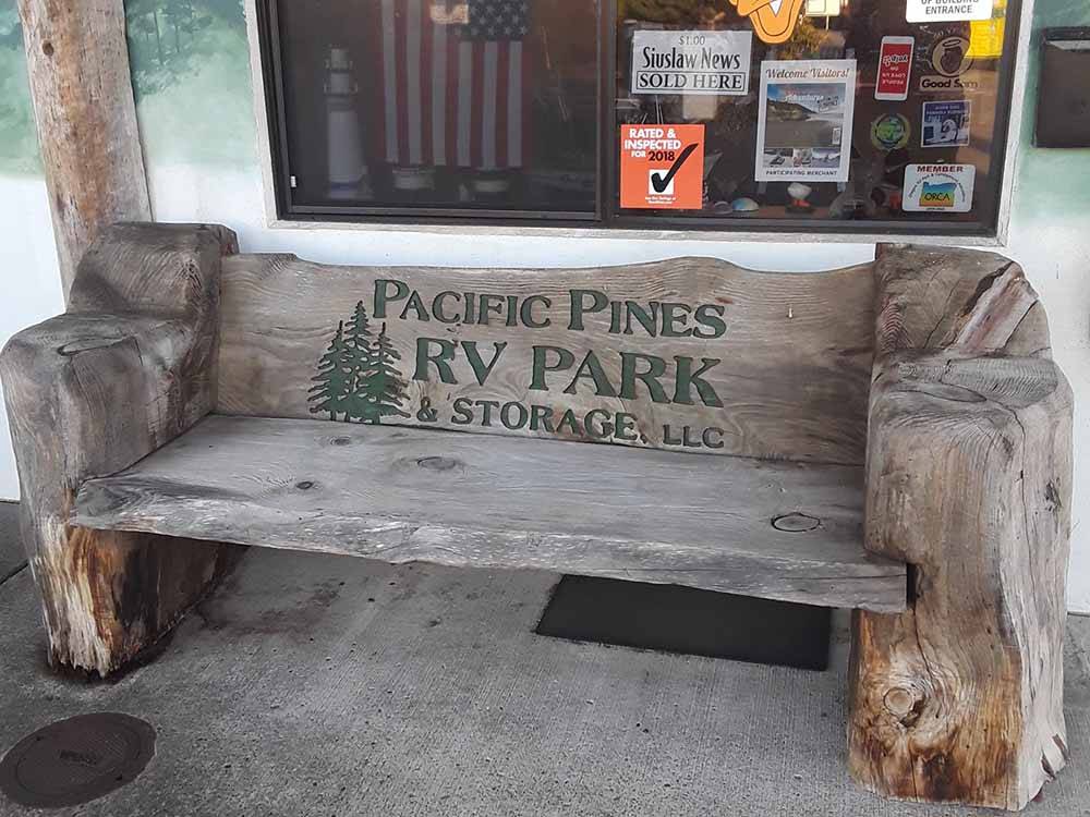 A rustic driftwood bench at PACIFIC PINES RV PARK & STORAGE