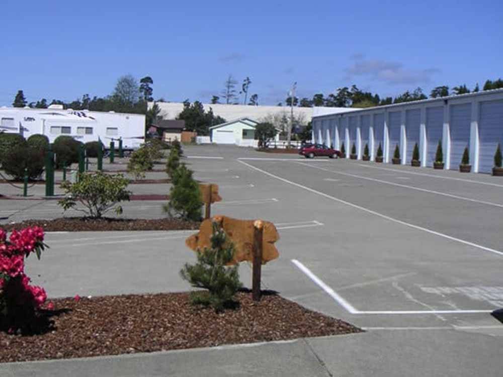 A row of RV sites and the indoor RV storage at PACIFIC PINES RV PARK & STORAGE