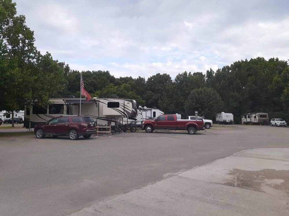 Various trailers parked on-site at OUTDOOR LIVING CENTER RV PARK