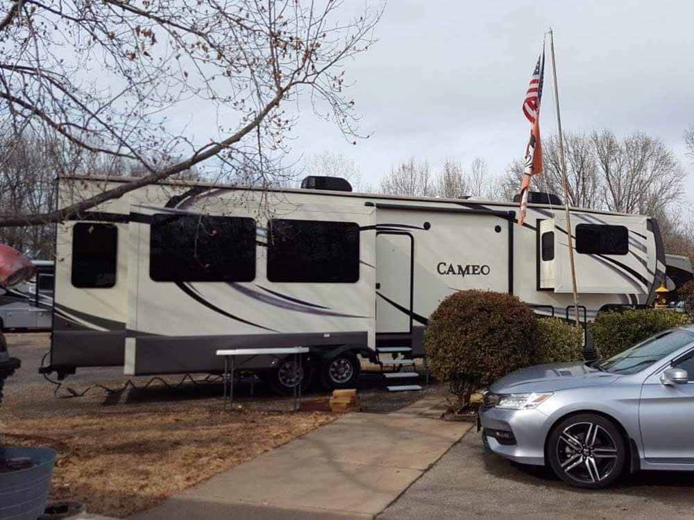Fifth wheel parked at RV site at OUTDOOR LIVING CENTER RV PARK