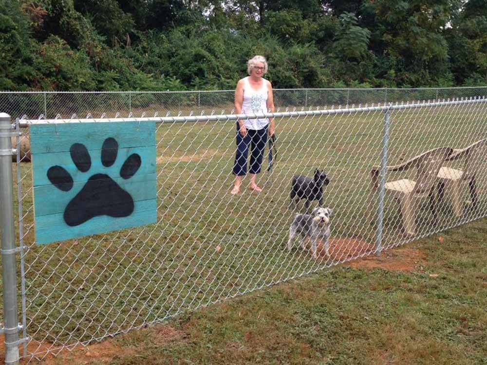 Fenced-in area for pets at OUTDOOR LIVING CENTER RV PARK