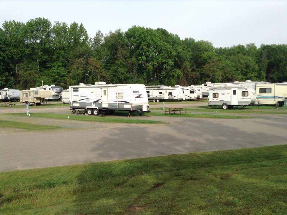 RVs parked at campground at OUTDOOR LIVING CENTER RV PARK