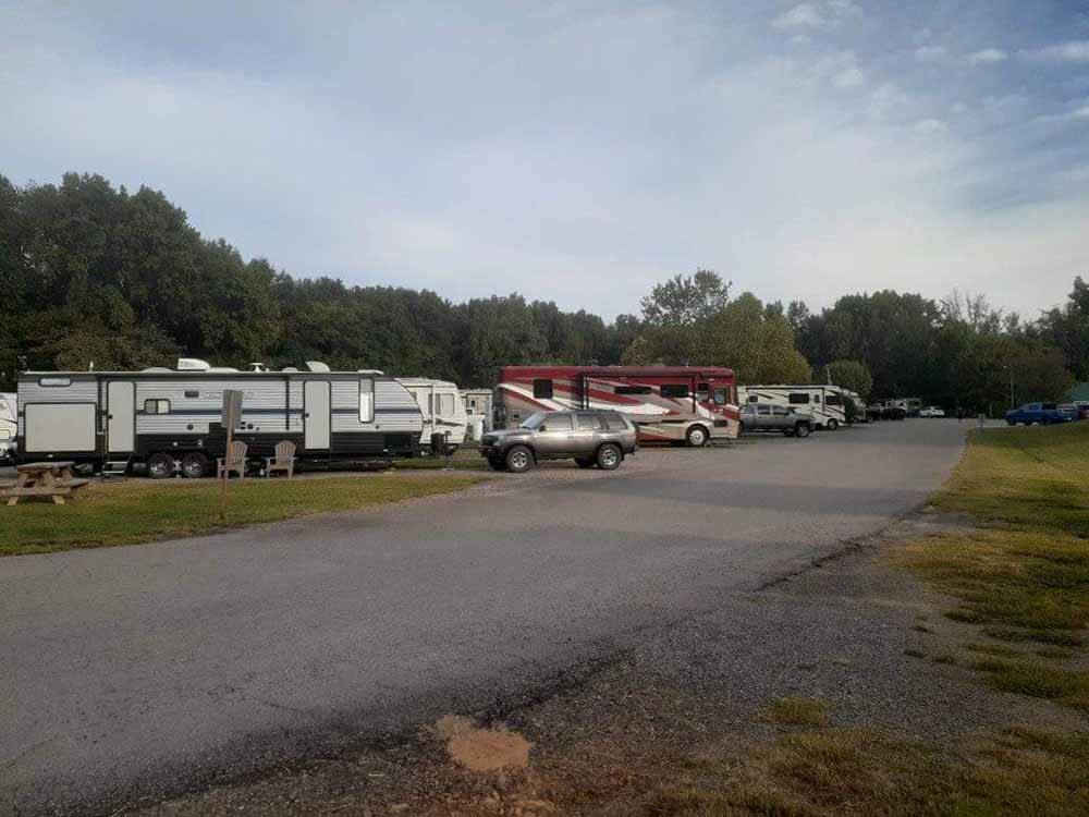Paved road leading to open area for RVs at OUTDOOR LIVING CENTER RV PARK
