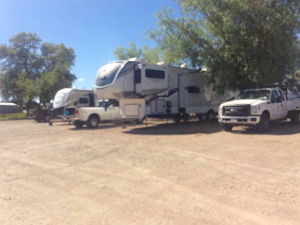 A row of fifth wheel trailers in RV sites at BLANDING RV PARK