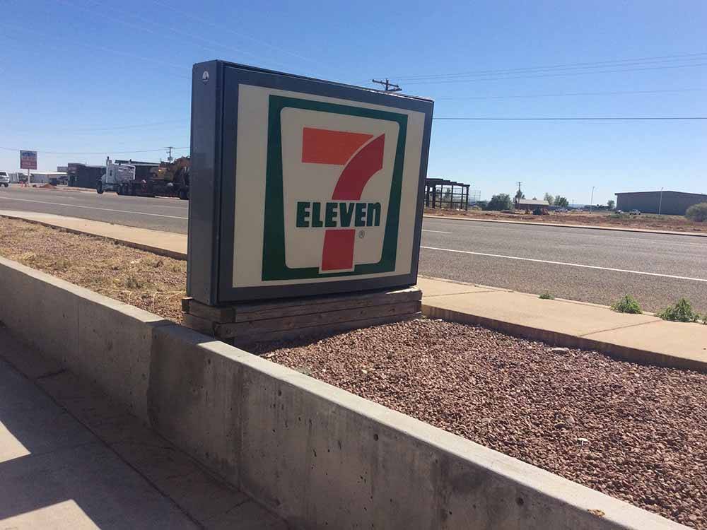 A seven-eleven sign next to the road at BLANDING RV PARK