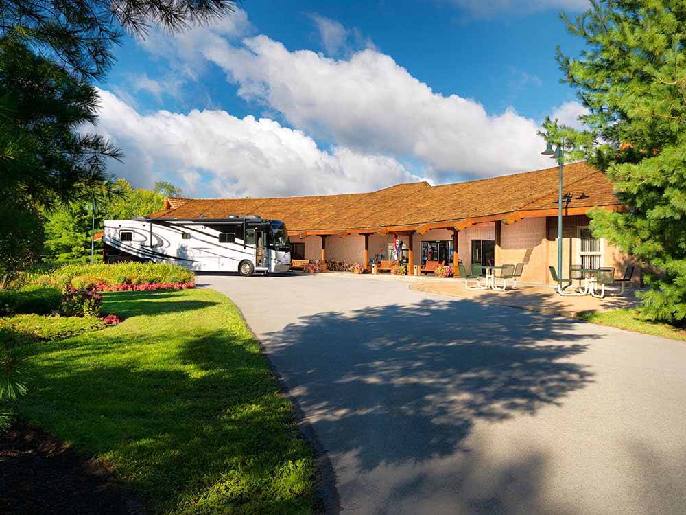 A motorhome in front of the main building at THE VILLAGES AT TURNING STONE RV PARK