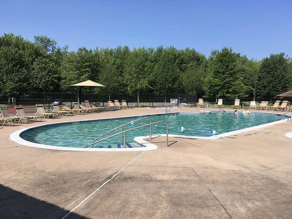 Swimming pool with outdoor seating at THE VILLAGES AT TURNING STONE RV PARK