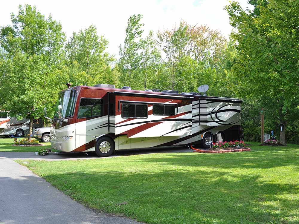 A motorhome in a back in RV site at THE VILLAGES AT TURNING STONE RV PARK