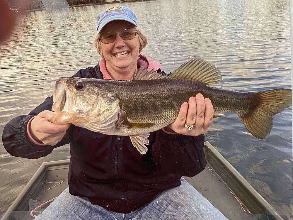 A lady holding a large fish at LAKE HARMONY RV PARK AND CAMPGROUND