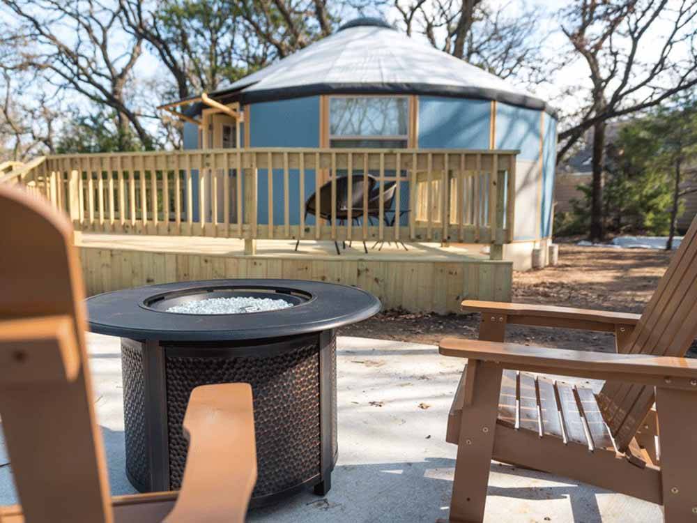 A fire pit next to a yurt at LOYD PARK CAMPING CABINS & LODGE